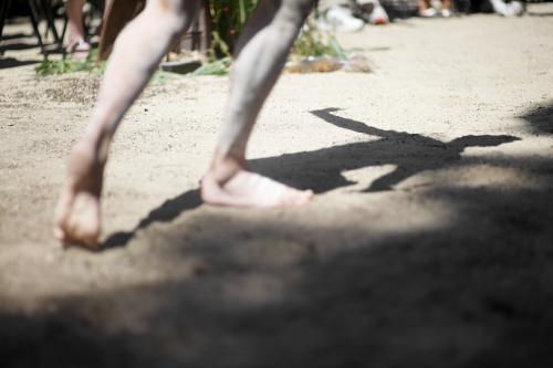 Shadow and Legs of an Aboriginal Dancer - Australian Stock Image