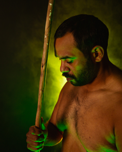 Shirtless aboriginal man holding a wooden spear - Australian Stock Image