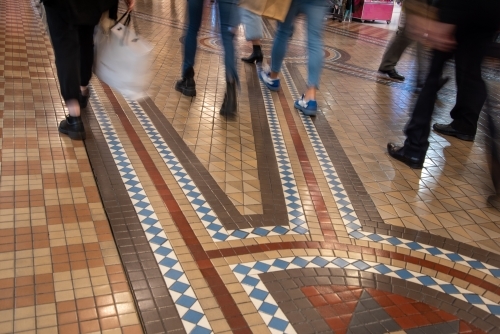 Shoppers walking on tiled floor - Australian Stock Image