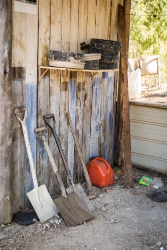 Shovels and fossicking sieves in old wooden shack - Australian Stock Image