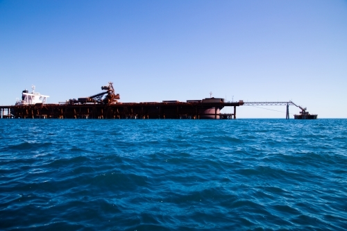 Side view of freight ship docked for loading - Australian Stock Image
