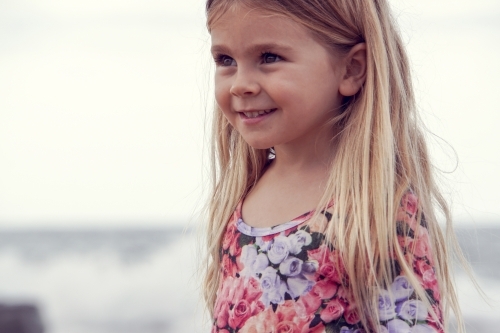 Side view of young girl on beach - Australian Stock Image