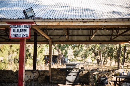 Sign on old picnic area with bbq and iron roof - Australian Stock Image