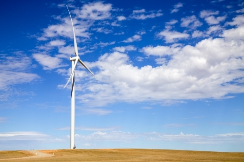 Single wind tower on hilltop - Australian Stock Image
