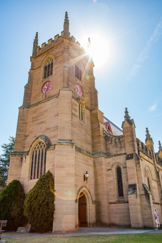 Singleton Anglican Church building with sun lens flare - Australian Stock Image