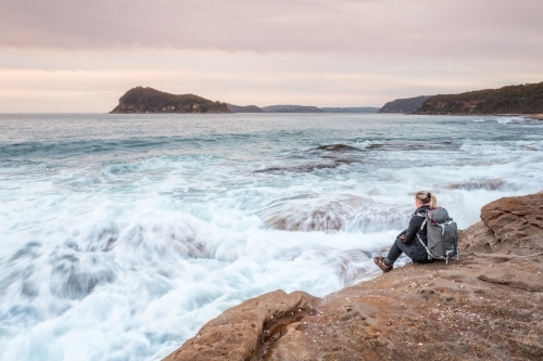 Sitting by the shore letting the waves wash in to meet you. - Australian Stock Image