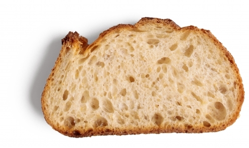 Slice of sourdough bread on white background - Australian Stock Image