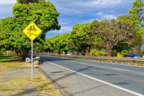 Slippery road warning sign for push bikes and cars driving on sealed roads in suburban areas - Australian Stock Image