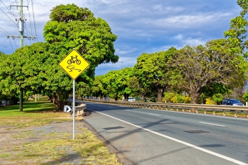 Slippery road warning sign for push bikes and cars driving on sealed roads in suburban areas cropped - Australian Stock Image