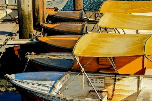 Small boats for hire tied up at jetty - Australian Stock Image