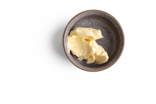 Small bowl of butter on white background - Australian Stock Image