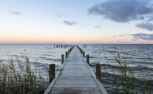 small jetty on lake at sunset - Australian Stock Image