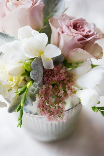 small vase filled with beautiful pastel flowers - Australian Stock Image