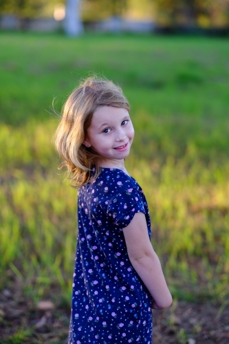 Smiling girl in a field - Australian Stock Image