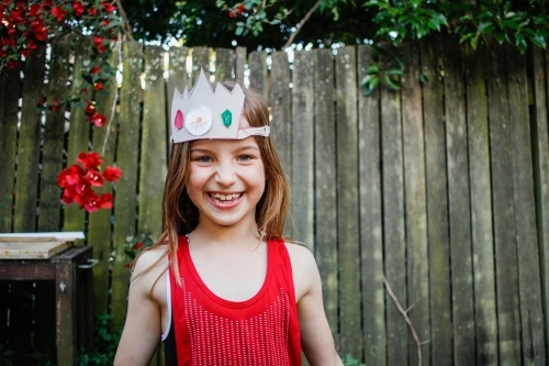 Smiling girl wearing a paper crown - Australian Stock Image