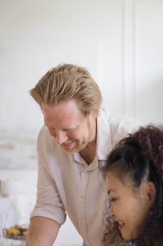 Smiling man serving meal to his wife