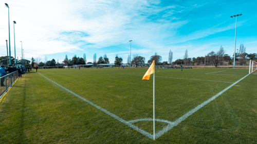 Soccer field corner with yellow flag. - Australian Stock Image