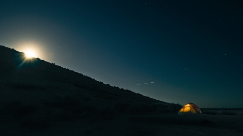 Solo Camping on a full moon's night in a tent - Australian Stock Image