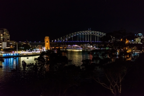 Spectacular view of Sydney Harbour Bridge at night with passenger liner and Sydney Opera House. - Australian Stock Image