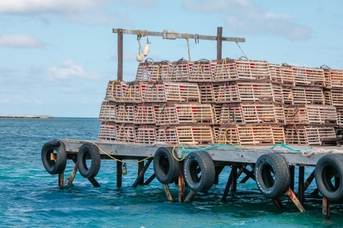 Stacks of craypots on a wooden jetty - Australian Stock Image