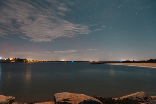 Starry night over the Iluka breakwall, long exposure astrophotography - Australian Stock Image