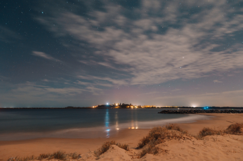 Starry night sky over Yamba NSW with pink tinge of Aurora Australis - Australian Stock Image