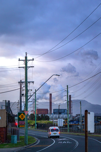 Steel Smelter behind power lines and poles - Australian Stock Image