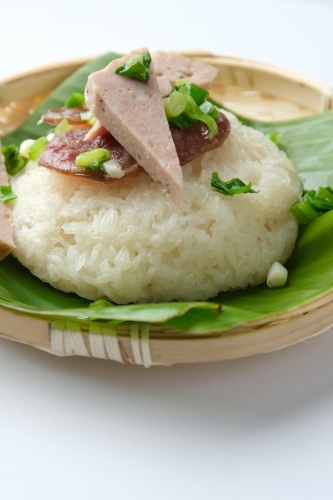 Sticky rice topped with green onions and meatloaf . - Australian Stock Image