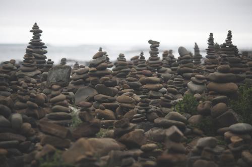 Stone piles at Cairn Beach - Australian Stock Image