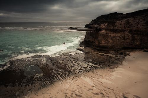 Storm clouds gathering over a pristine beach - Australian Stock Image