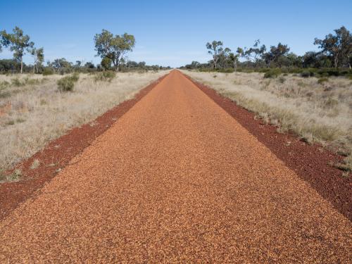 Straight sealed bitumen road disappearing in the distance - Australian Stock Image