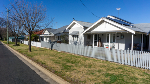 Street with houses in a country town on a sunny day - Australian Stock Image