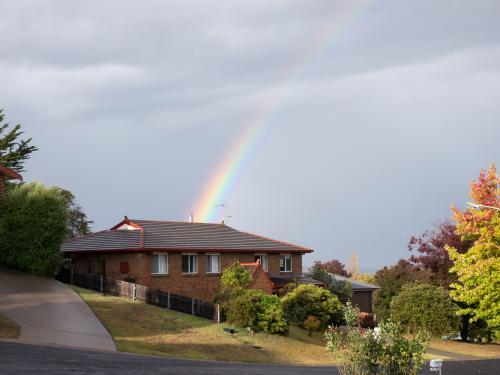 Suburban house with rainbow - Australian Stock Image