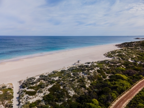 Summer in Perth with white sand, green trees. ocean water, clouds and a path - Australian Stock Image