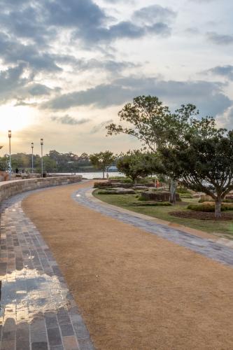 Sun setting over Barangaroo walking path and gardens - Australian Stock Image