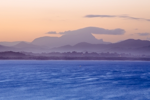 Sun setting over Mt Warning and Byron bay - Australian Stock Image