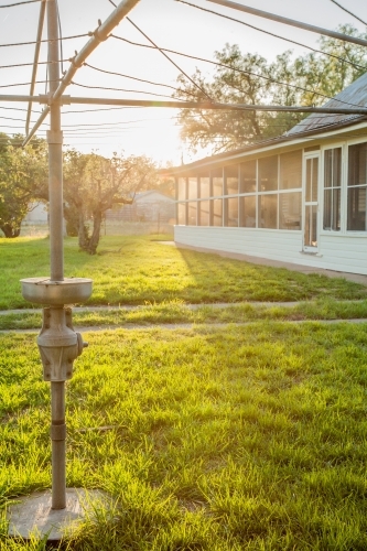 Sunlight shining through clothesline in homestead backyard - Australian Stock Image