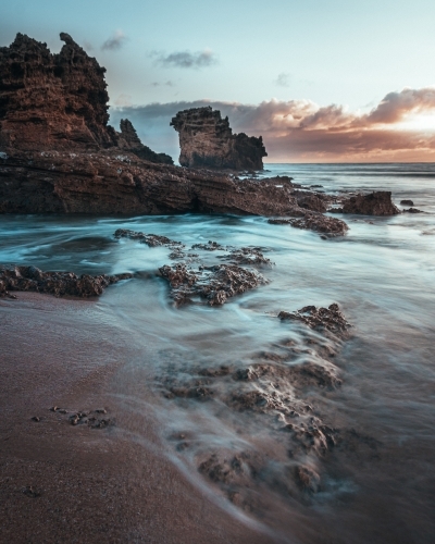 Sunrise at a Rocky Mountainous Beach - Australian Stock Image