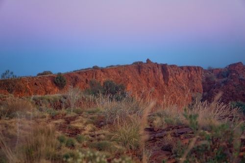 Sunrise glow from the top of Mount Bruce in Karijini Western Australia. - Australian Stock Image