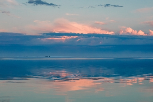 Sunrise reflected on glassy ocean