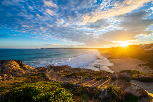 sunset above the Encounter Bay viewed across Boomer Beach, Port Elliot, South Australia - Australian Stock Image