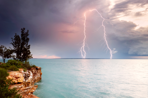 Sunset Lightning Strike over cliffs around Darwin - Australian Stock Image