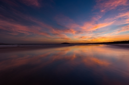 Sunset over calm ocean water - Australian Stock Image