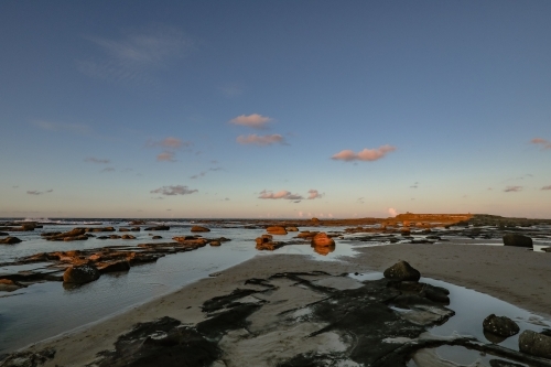 Sunset over rocky shelf at Norah Head, NSW Australia - Australian Stock Image