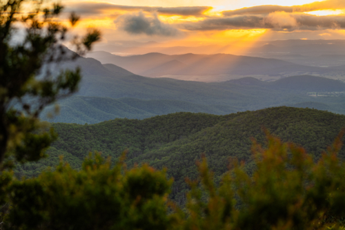 Sunset rays over scenic mountain landscape - Australian Stock Image