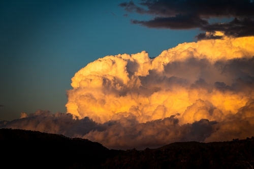 Sunset reflected on clouds in evening sky - Australian Stock Image