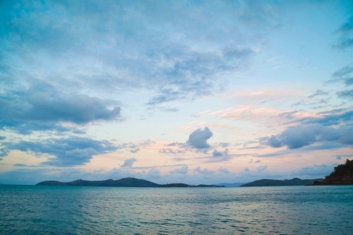 Sunset view of islands off Coral Beach at Shute Harbour in Queensland - Australian Stock Image