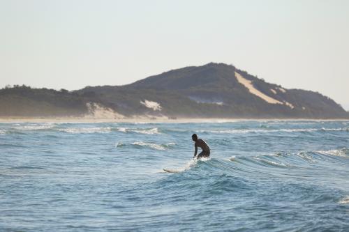 Surfer with mountain in background - Australian Stock Image