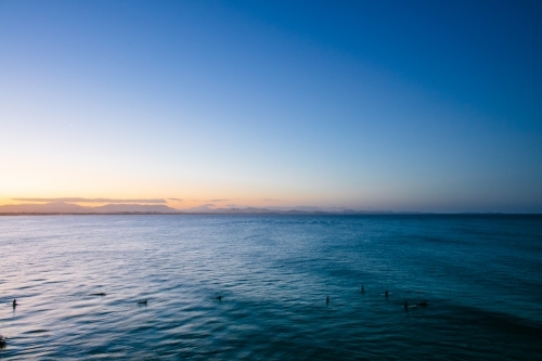 Surfers in the water at The Pass - Australian Stock Image