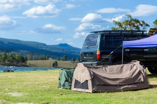 Swags and gazebo at lakeside campground on Australia Day - Australian Stock Image